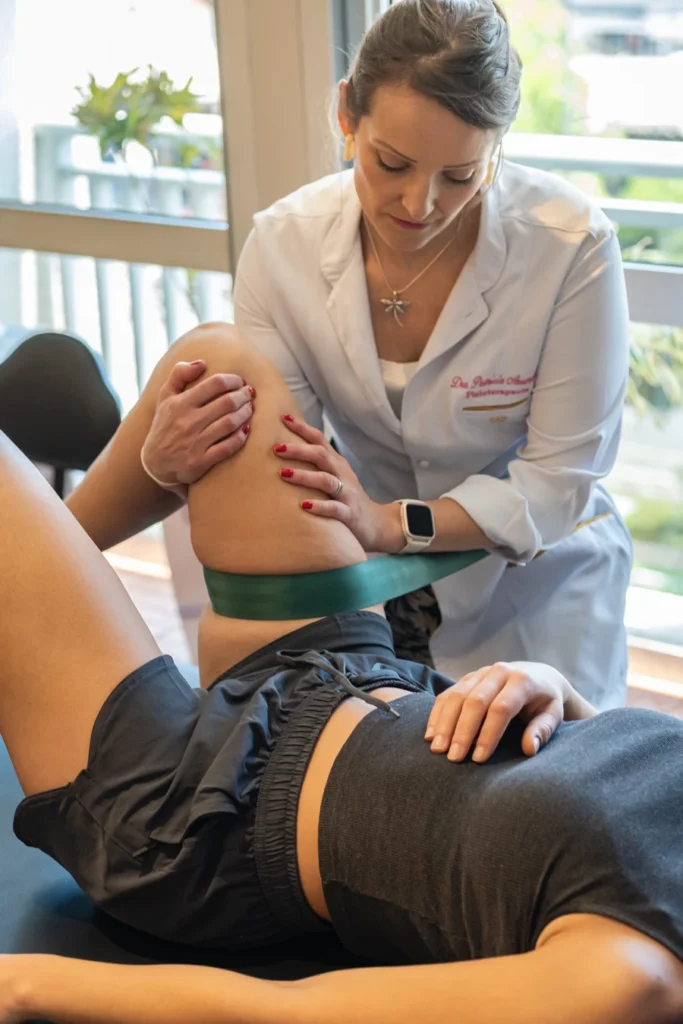 Fisioterapeuta realizando técnica de mobilização do quadríceps durante atendimento na clínica Fisioprax em São Paulo